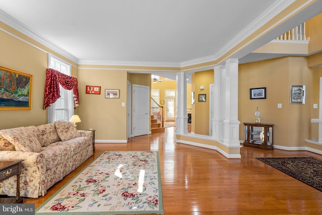 living room featuring ornamental molding, ornate columns, and light hardwood / wood-style floors