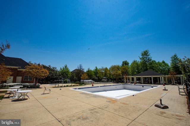 view of swimming pool with a patio and a gazebo