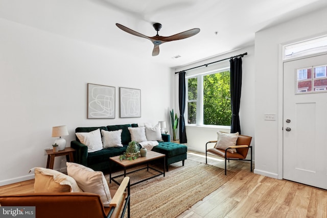 living room featuring ceiling fan and light hardwood / wood-style flooring