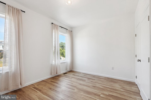 spare room featuring light hardwood / wood-style floors