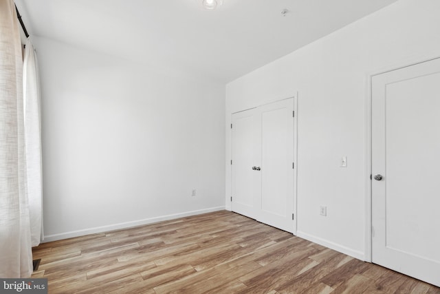 unfurnished bedroom featuring light wood-type flooring