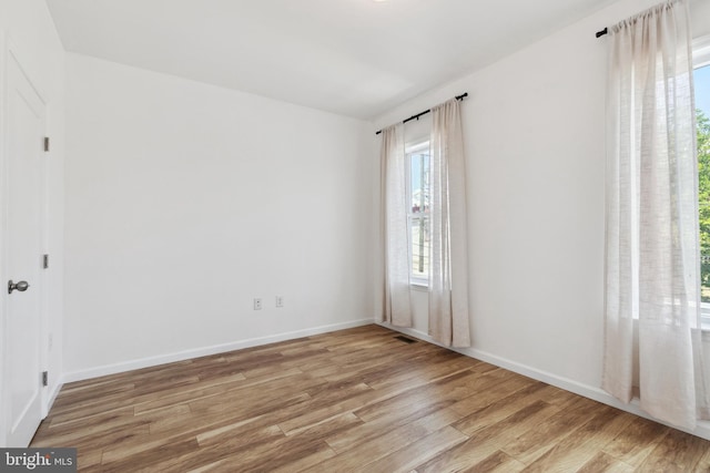 spare room with light wood-type flooring