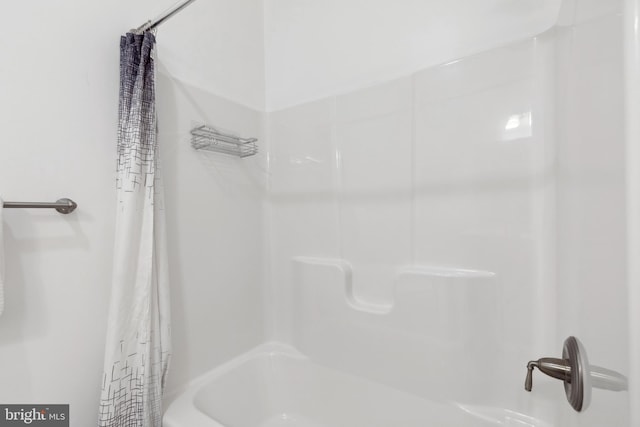 bathroom with shower / bath combination with curtain