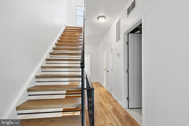 stairs with wood-type flooring