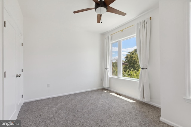 empty room with carpet and ceiling fan