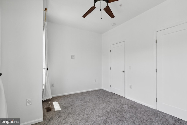 interior space with ceiling fan and dark colored carpet