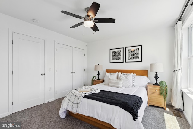 bedroom featuring ceiling fan, dark carpet, and a closet