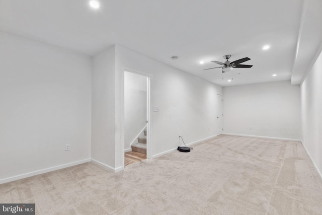 carpeted spare room with ceiling fan