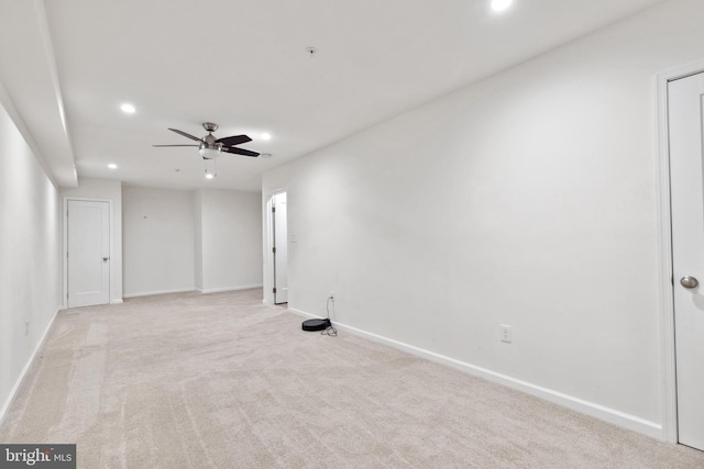 unfurnished room with light carpet and ceiling fan