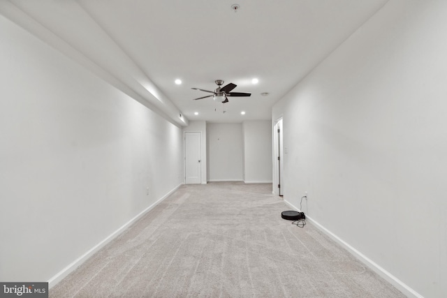 empty room featuring light carpet and ceiling fan