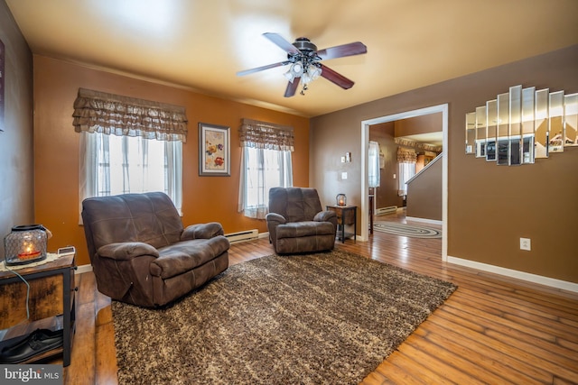 living room featuring ceiling fan, wood-type flooring, and a baseboard radiator