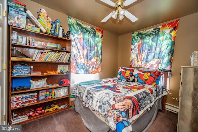 carpeted bedroom featuring a baseboard heating unit and ceiling fan