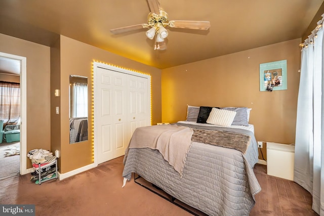 carpeted bedroom with ceiling fan and a closet