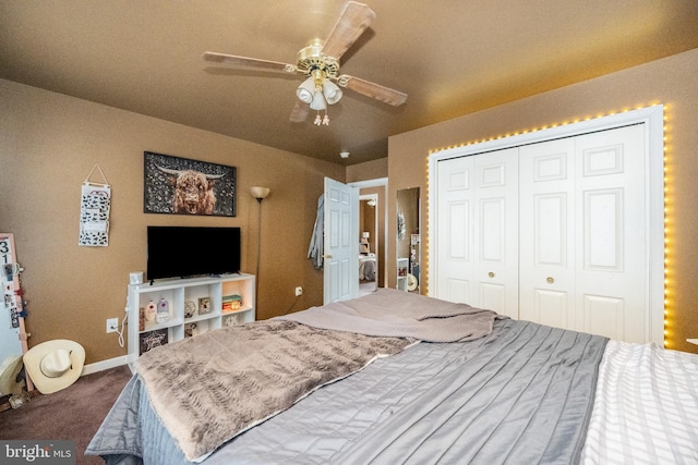 carpeted bedroom with ceiling fan and a closet