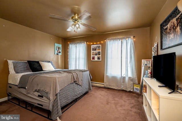 carpeted bedroom featuring ceiling fan and baseboard heating