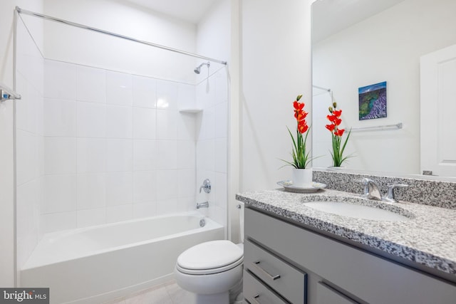 full bathroom featuring tile patterned floors, toilet, vanity, and tiled shower / bath