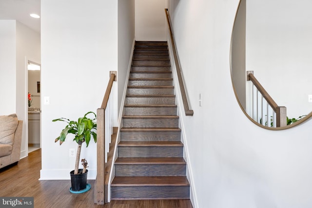 stairs with wood-type flooring