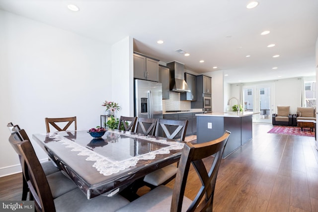 dining room with sink, dark hardwood / wood-style flooring, and french doors