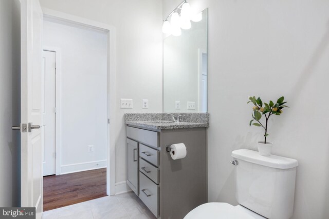 bathroom with vanity, toilet, and tile patterned flooring