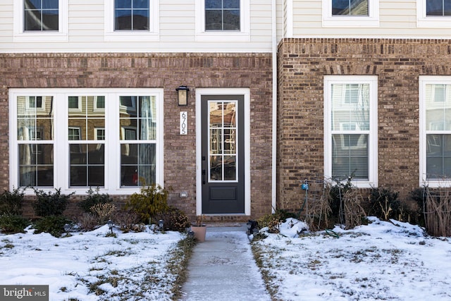 view of snow covered property entrance