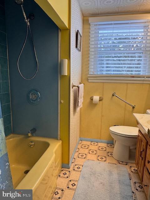 full bathroom featuring vanity, shower / tub combo, and toilet