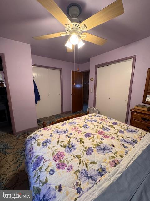 bedroom featuring ceiling fan and a closet