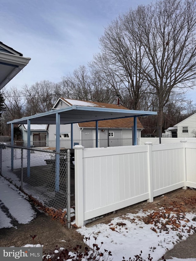 view of snowy exterior featuring a carport