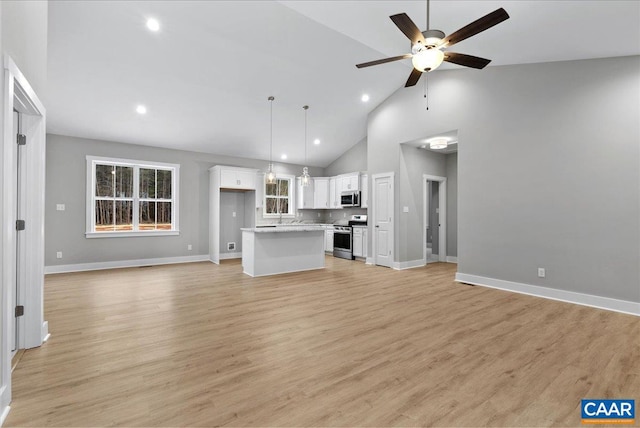 unfurnished living room featuring ceiling fan, light wood-type flooring, and high vaulted ceiling