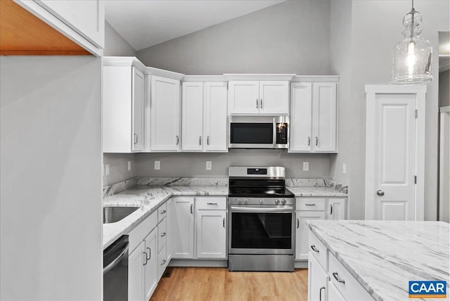 kitchen featuring lofted ceiling, white cabinets, and appliances with stainless steel finishes