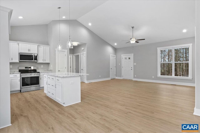 kitchen featuring a center island, pendant lighting, white cabinetry, appliances with stainless steel finishes, and high vaulted ceiling