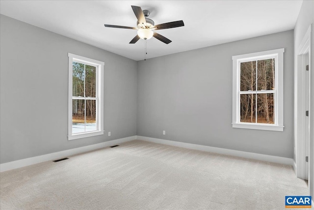 carpeted spare room with ceiling fan