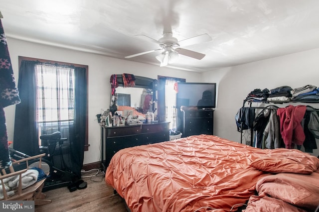 bedroom with hardwood / wood-style flooring and ceiling fan