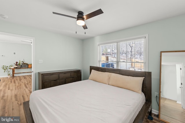 bedroom with hardwood / wood-style floors and ceiling fan