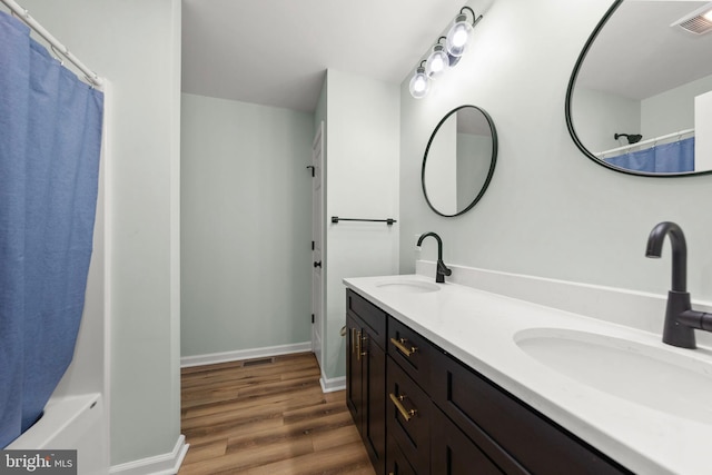 bathroom with vanity and hardwood / wood-style floors