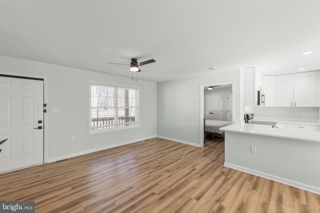 interior space featuring light hardwood / wood-style floors and ceiling fan