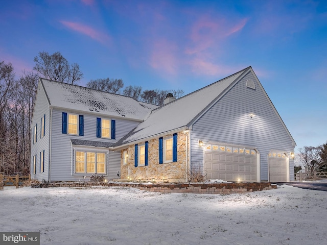 property exterior at dusk with a garage