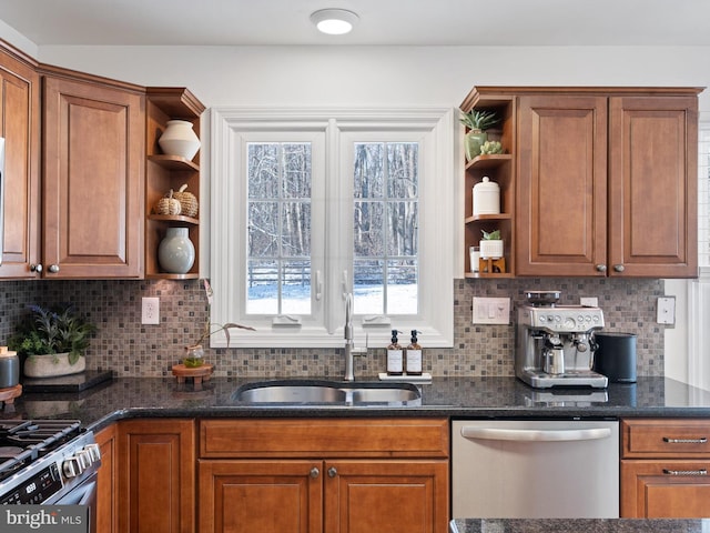 kitchen with decorative backsplash, sink, dark stone countertops, and stainless steel appliances