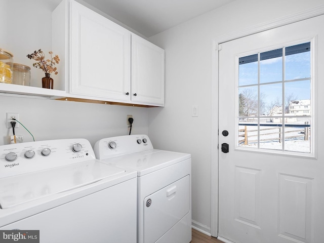 laundry area with cabinets and washer and clothes dryer