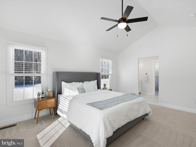 bedroom with ceiling fan, light colored carpet, multiple windows, and high vaulted ceiling