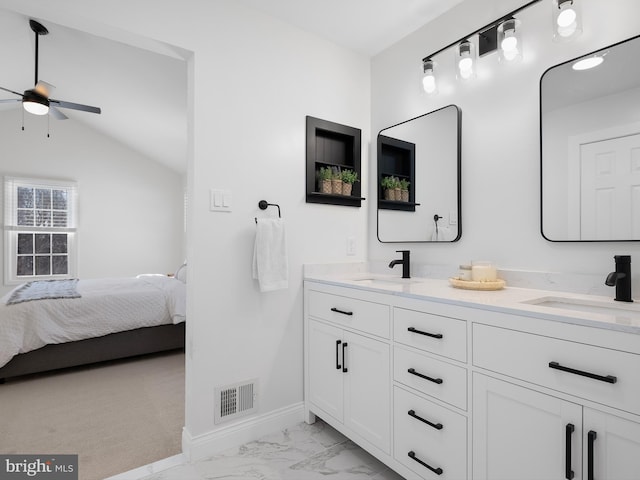 bathroom with ceiling fan, vanity, and lofted ceiling