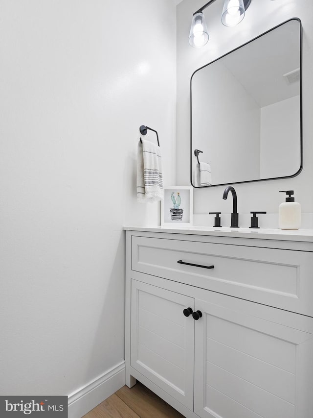 bathroom with hardwood / wood-style flooring and vanity