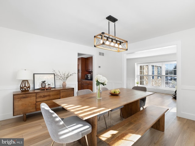 dining space with light hardwood / wood-style flooring