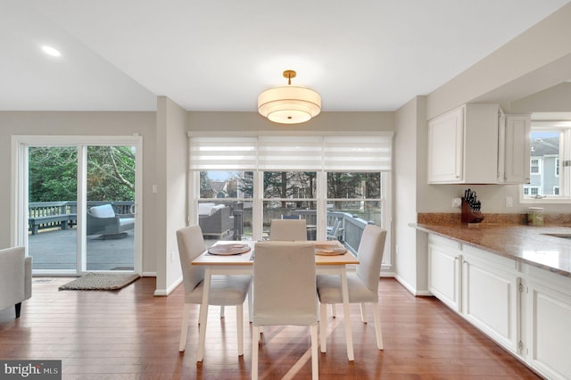 dining area with dark hardwood / wood-style floors