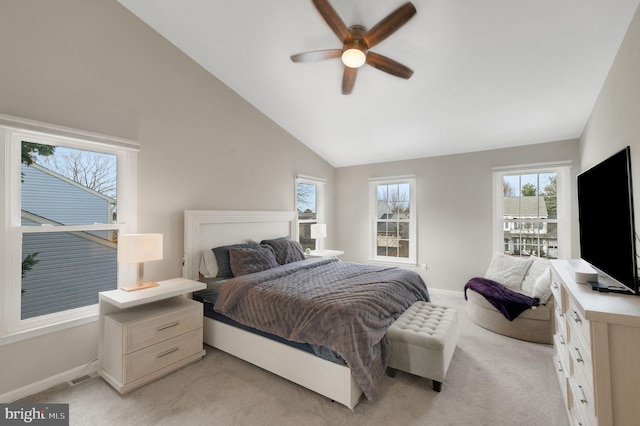 carpeted bedroom with vaulted ceiling and ceiling fan