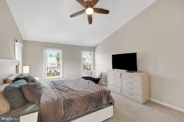 bedroom featuring lofted ceiling, light colored carpet, and ceiling fan