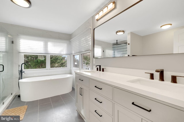 bathroom featuring tile patterned flooring, plus walk in shower, and vanity