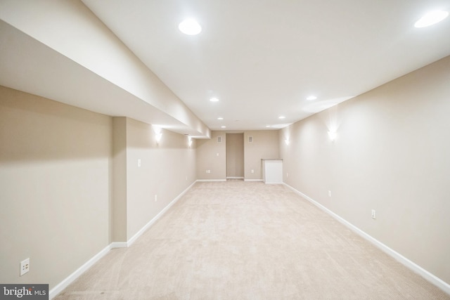 basement featuring light colored carpet