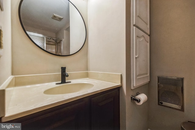 bathroom with vanity and a shower with door