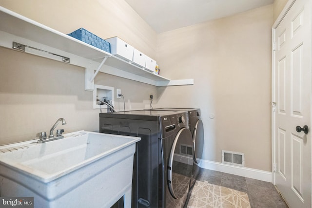 laundry room with washer and dryer and sink