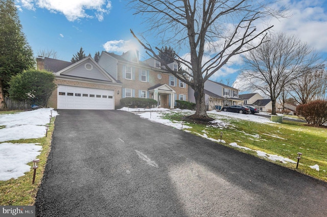 view of front of property with a garage and a front lawn